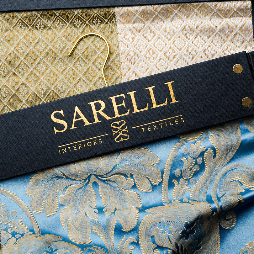 Sarelli fabric hanger on a blue and gold damask
